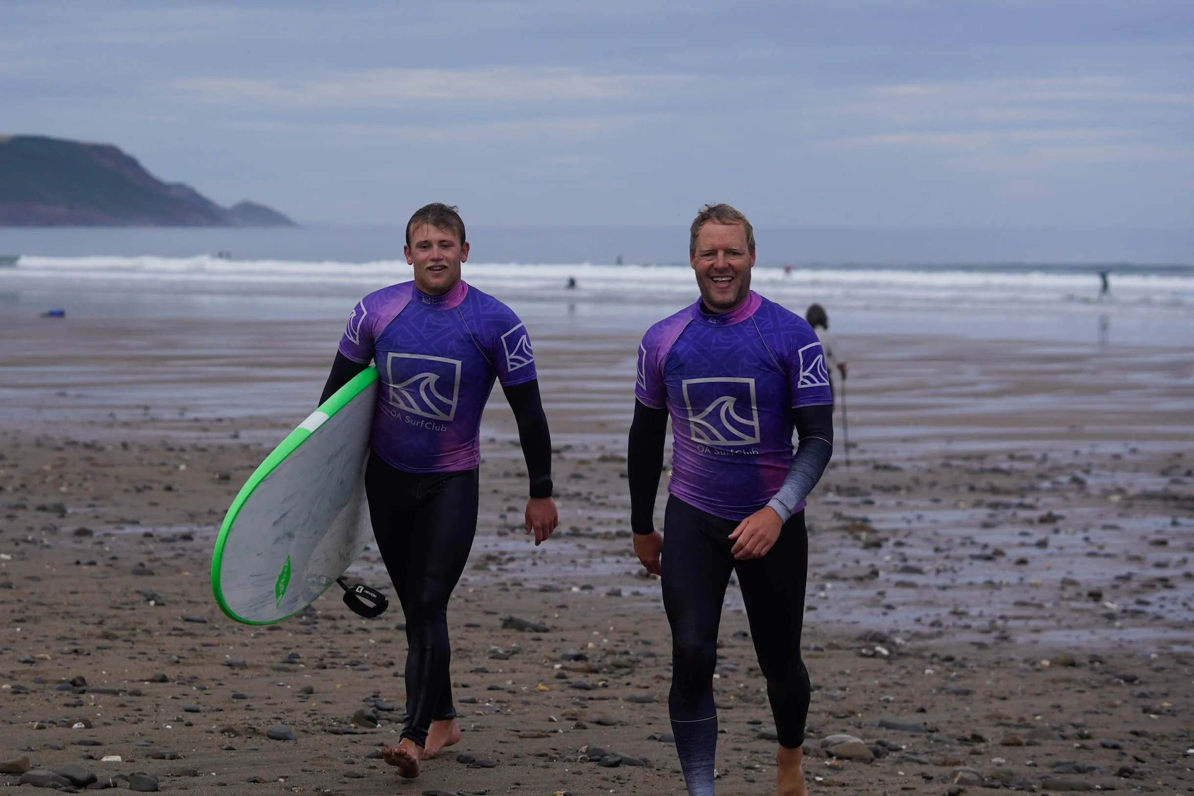 oa surf club team walking up the beach at Widemouth Bay