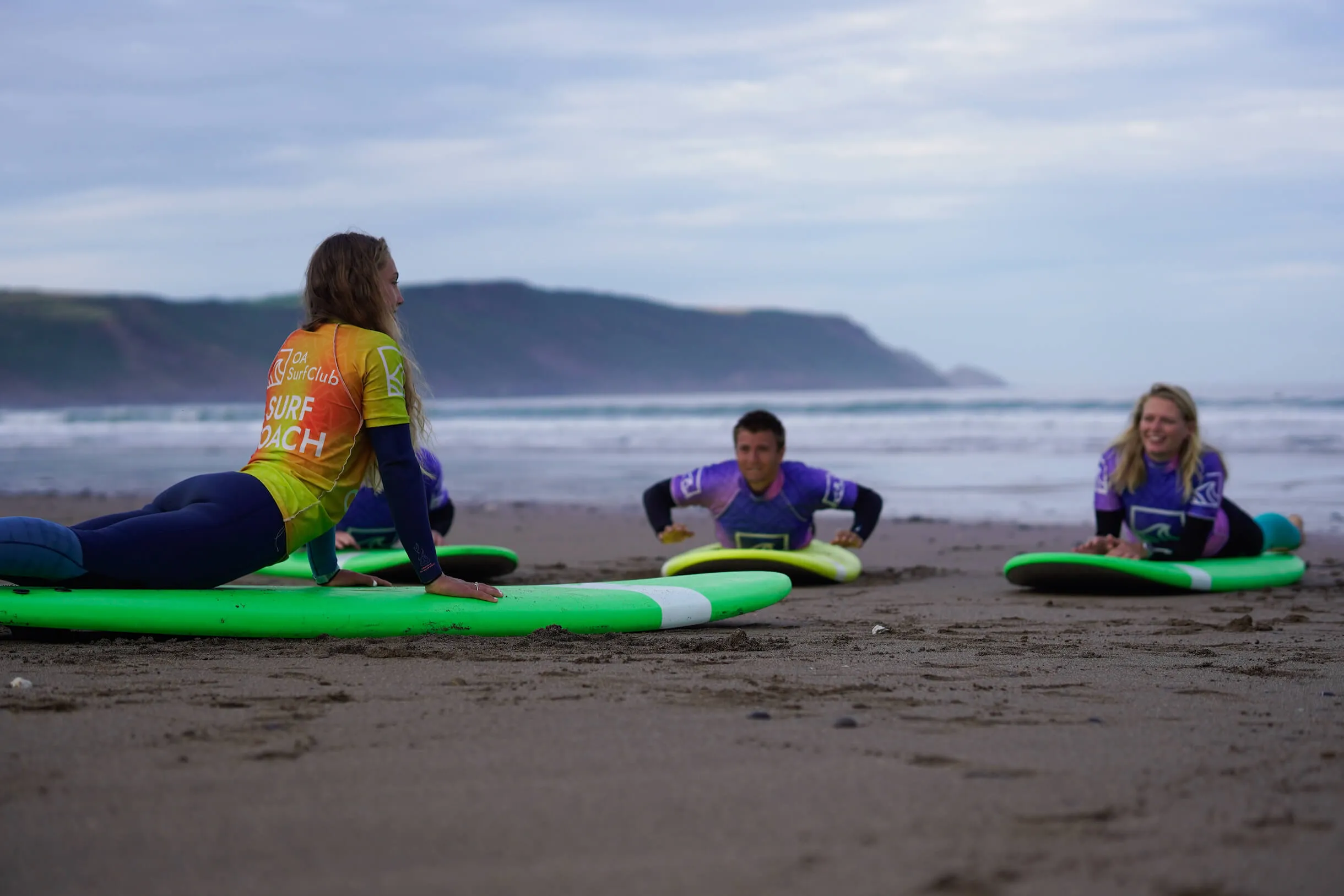 surf lessons in Widemouth Bay, Bude, surf coach coaching on the beach before heading in the water