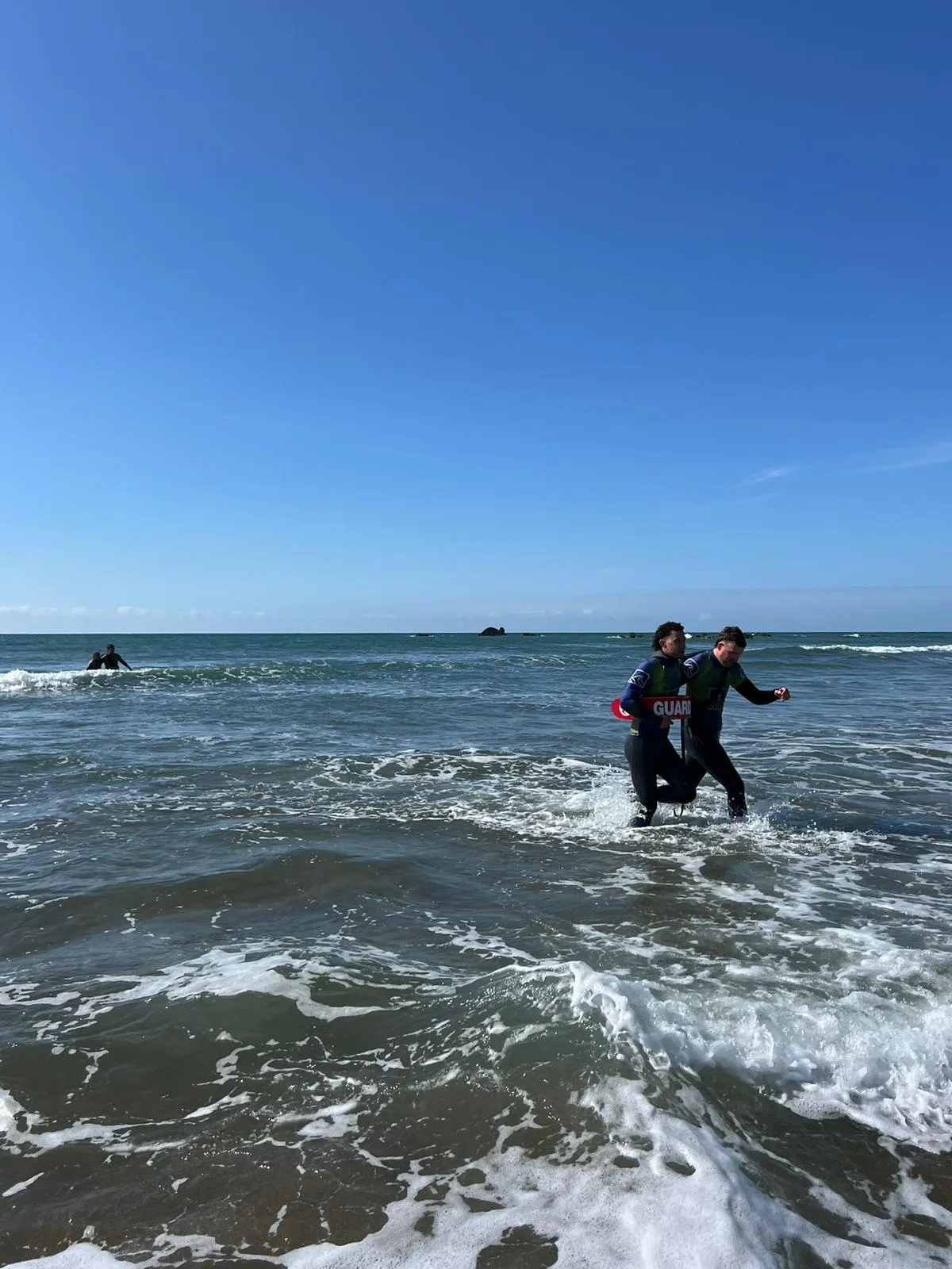 beach lifeguard rescuing someone from the sea