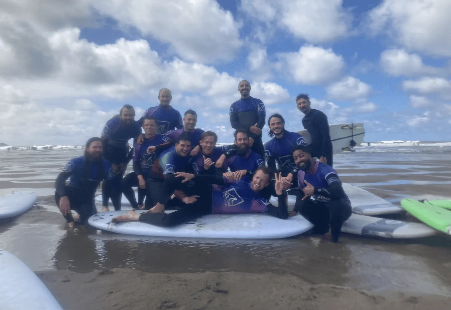 stag group surfing at widemouth bay, dressed in wetsuits