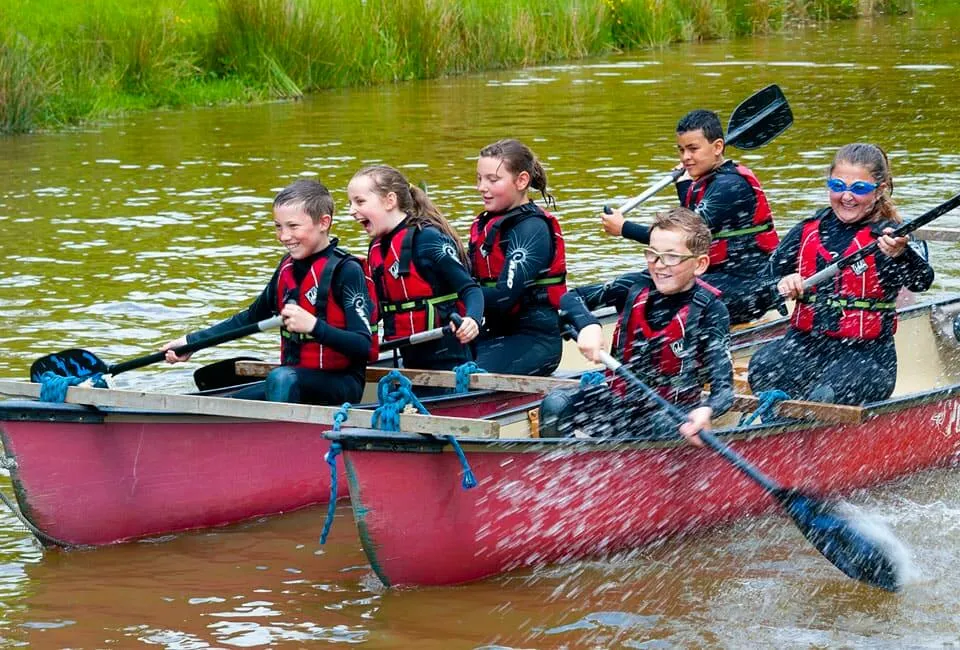 children canoeing on bude canal whilst on a school residential