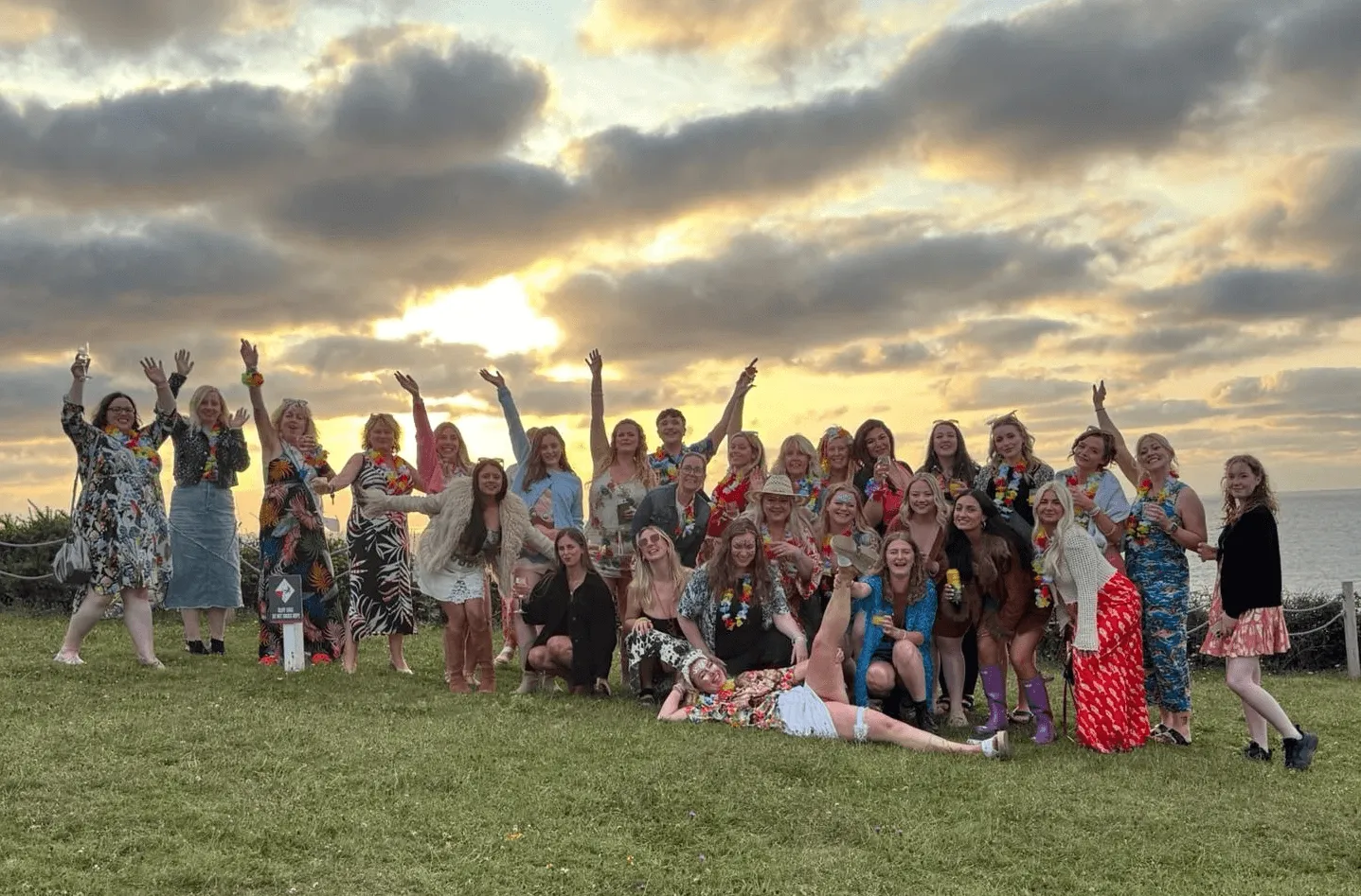 hen group posing for a picture with the sunset in the background at OA Surf Club
